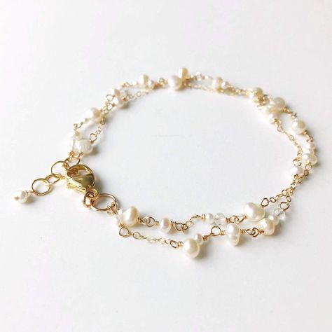 "Poppy Linen Bracelet" is perfect for our pearl lovers out there. Dainty and simple yet makes a beautiful statement. Pair it with a classic Caroline bangle for an elevated look.  - Two strands of dainty white pearls in various shapes and sizes are accented by small chain. Small, faceted crystal quartz add a hint of shi Delicate Gold Bracelet, Hand Jewelry Rings, Gold Pearl Bracelet, Pearl Bracelet Gold, Dainty Gold Bracelet, White Bracelet, Jewellery Sketches, White Bracelets, Jewelry Lookbook