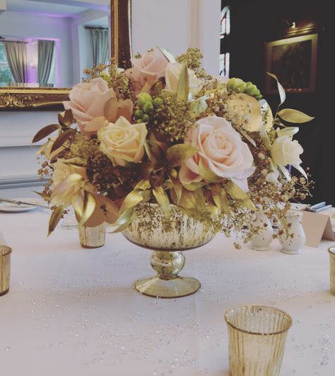 Pretty gold rose bowl filled with gold foliage sand blush roses. Bowl Centerpieces, Anniversary Reception, Gold Foliage, Wooden Walking Sticks, Rose Bowl, Wedding Show, Centerpiece Bowl, Table Arrangements, Blush Roses