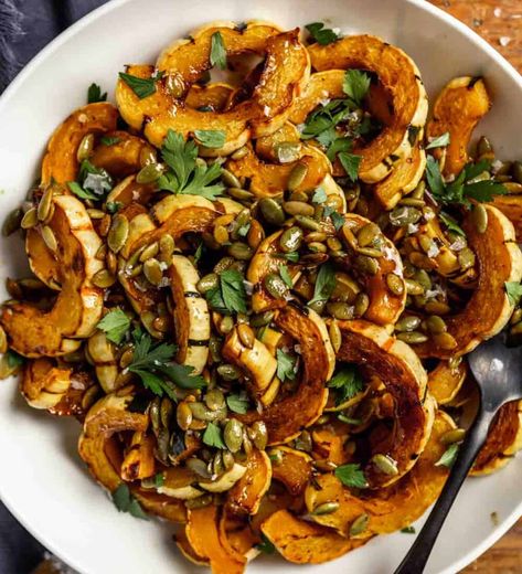 Golden-brown roasted delicata squash slices get drizzled with a maple browned butter sauce, toasted pepitas and flaky sea salt. Simple (less than 10 ingredients!) and flavorful, this winter squash side dish is ideal for weeknight dinners and holiday dinners. How To Roast Delicata Squash, Maple Delicata Squash, Maple Roasted Delicata Squash, Roasted Delicata Squash Recipe, Delicate Squash Recipes, Beef Side Dishes, Brown Butter Squash, Squash Sides, Delicata Squash Roasted