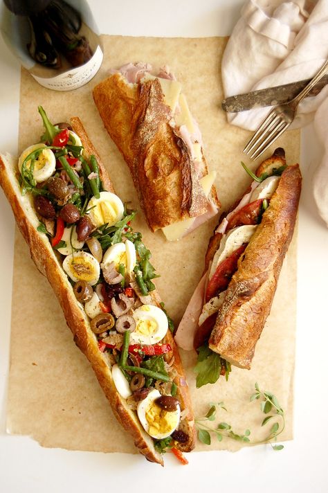 Picnic on the Seine: At Home Edition. Bring a little Paris to your kitchen with these classic French baguette sandwiches, easy to make but substantial enough to be a chic, no-cook dinner. Jambon Beurre is French ham and cheese, and tomato goat cheese makes a juicy, savory option. Pan bagnant is a tuna vegetable sandwich with major wow factor. Lunch gets some "oh la la." . . . . . #fallrecipes #lunch #frenchrecipesauthentic #easyrecipes #fallfooddinner #tunasandwich #ham #cheese #nicoise Sandwich With Baguette, French Sandwich Baguette, Best Baguette Sandwiches, Baguette Recipe Sandwich, French Baguette Ideas, French Lunch Recipes, How To Make A Wrap Sandwich, French Lunch Ideas, Baguette Sandwich Recipes