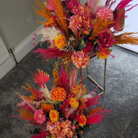 Beautiful pampas centerpieces placed on metal table stands/plinths Made with a mix of pink and orange pampas grass, dried flowers, and the single stem flowers are all artificial. With my custom palms to match the wedding scheme. I actually show myself sometimes 😆. I absolutely loved making these decorations. My workshop is completely bare now they have all gone. If you would like to discuss your wedding flowers, please send a message and I would be happy to help. All of these decorat... Pampas Centerpieces, Stem Flowers, Pink White Flowers, Wedding Tables, Pink And White Flowers, Fruit Of The Spirit, Pampas Grass, Metal Table, Wedding Stuff