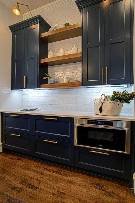 Blue cabinets with open walnut shelves and gold accents in hardware and lighting Navy Cabinets With White Countertops, Navy Blue Kitchen Cabinets Open Shelving, Navy Cabinets Gold Hardware, Blue Cabinet Gold Hardware, Blue Wall Kitchen Wood Cabinets, Navy Blue Built In Cabinets, Navy And Gold Cabinets, Blue Cabinets With Gold Handles, Navy Kitchen Cabinets Gold Hardware