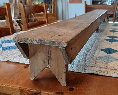 Offering this amazing small primitive wood bench.  Measures 5 foot long and constructed with both square & round nails. Well worn patina with a wonderful farmhouse appeal. Stands 5.5" tall and measures 5.5" wide. Great presentation as a riser on an old farm table but there are many uses. In great, sturdy condition with wear consistent with age. Nice apron boards grace both sides revealing three bootjack legs underneath.  Please view all photos as they are part of description and reach out with any questions. Thank you for viewing my listing. Great Presentations, Round Nails, Primitive Decor, Wood Bench, Old Farm, Farm Table, Primitive Decorating, Home Accents, Patina