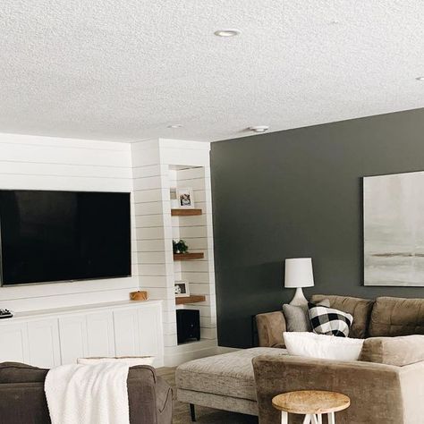 heather barta | simplified home on Instagram: "I haven’t shown our finished basement too much but it is our favorite hangout spot! I have a lot of questions the other day after posting about my carpet cleaning so I thought I would share a little more. The color is sw westchester gray, Chris built that amazing shiplap built in and the carpet is the stainmaster Medford carpet from Lowe’s in buried treasure. I painted over a huge $20 canvas for that big art piece!  Just a few more things to add like shelves in the bar area, barn doors and some photos on the walls to make it feel like home. #bartasmodernfarmhouse" Heather Barta, Westchester Gray, Simplified Home, Hangout Spot, Buried Treasure, Feel Like Home, Finished Basement, Bar Area, Big Art