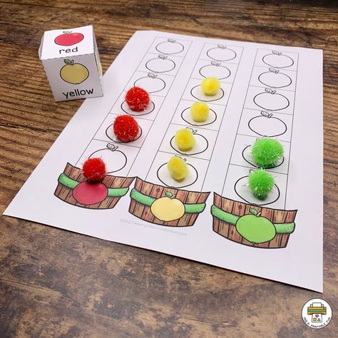 Roll and color games are a lot of fun and can be used in different ways. Roll the playing cube then place a counter on the correct column, or color in with a crayon. This activity is great for math and fine motor skill development. #earlylearning #kindergarten #kids #teachersofinstagram #prek #fun #toddlerlife #play Apple Theme Activities For Preschool, Apples Fine Motor Activities, Apple Games, Apple Small Group Activities Preschool, Apple Theme Games, Apple Themed Gross Motor Activities, Apple Large Motor Activities, Apple Tree Number Matching Activity, Apple Literacy