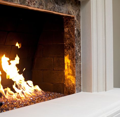 Fire glass, fire crystals or fireplace glass are ornamental pieces of rocks, glass or crystals. They are placed in fireplaces to create a modern, clean and lovely look. #homedecor #interiordesign #interiordesigner #homestyle #homedesign #decoration Fireplace Glass Rocks, Fireplace Decorating Ideas, Fire Glass Fireplace, Electric Fireplace Logs, Fireplace Decorating, Fireplace Glass, Electric Logs, Fire Rocks, Fireplace Doors