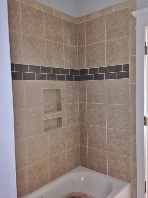 12x12 porcelain tile on tub walls with porcelain accent strip Tub Surround Tile Ideas, Wall Shower Ideas, Tile Bathroom Tub, Beige Bathroom Tile, Bathroom Tiling Ideas, Beige Tile Bathroom, Bathroom Redo Ideas, Bathroom Wall Tile Design, Bathroom Layout Ideas