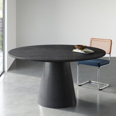 This modern round dining table brings a touch of sophistication to your dining space. With a pedestal base made from solid wood and an ebony black finish, this table adds a contemporary flair to your room. The top is crafted from engineered wood, showcasing natural wood grain color variation for a unique look. Seating up to six guests, this table is perfect for intimate gatherings or family dinners. Weighing in at 100 lbs. it offers stability without compromising on style. Wade Logan Colour: Ebo 48 Inch Round Table, Round Extension Dining Table, 60” Round Table, Mid Century Modern Round Dining Table, Modern Round Dining Room Table, Oval Marble Dining Table, Modern Oval Dining Table, Black Round Table, Black Round Dining Table