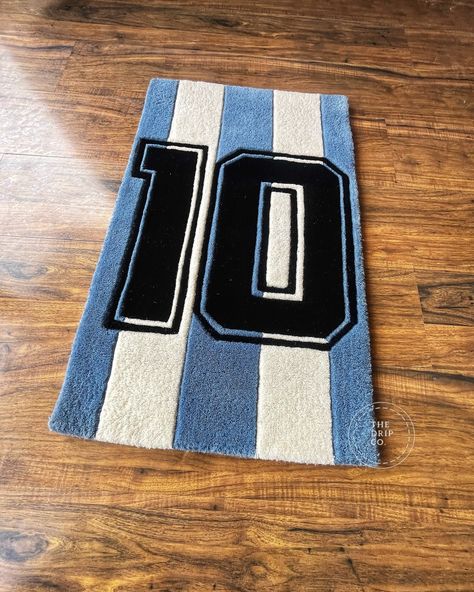 Introducing the Messi’s Jersey Rug, the ultimate tribute to the football legend Lionel Messi. Crafted with precision and passion, this rug features the iconic number 10 jersey design worn by Messi throughout his illustrious career. Made from high-quality materials, it adds a touch of sporting elegance to any room. Whether you’re a die-hard football fan or simply appreciate great design, the Messi 10 No. Jersey Rug is a must-have for your collection. Bring the spirit of the beautiful game into... Statement Rug, The Beautiful Game, Rug Ideas, Messi 10, Number 10, Great Design, Jersey Design, Die Hard, Football Fans