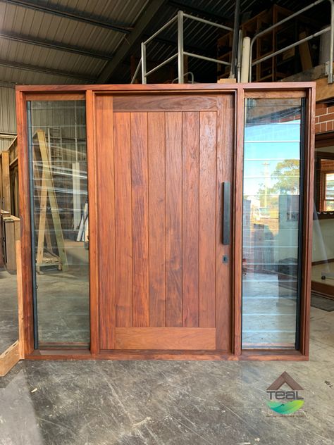 Vertical VJ timber entry door with louvre window sidelights either side. manufactured from Papua New Guinea Rosewood. Black pull handle. Front Door With Louvres, Large Wooden Front Door Entrance, Entry Door With Side Windows, Timber Door Design, Main Door With Window, Doors With Side Windows, Wood Entrance Door, Wooden Entrance Door, Wood And Glass Door