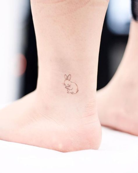 Ankle Tattoos: The Definitive Inspiration Guide • Tattoodo Hase Tattoos, Serotonin Tattoo, Ankle Band Tattoo, Cute Animal Tattoos, Bunny Tattoo, Ankle Tattoo Designs, Anklet Tattoos, Bunny Tattoos, Rabbit Tattoos