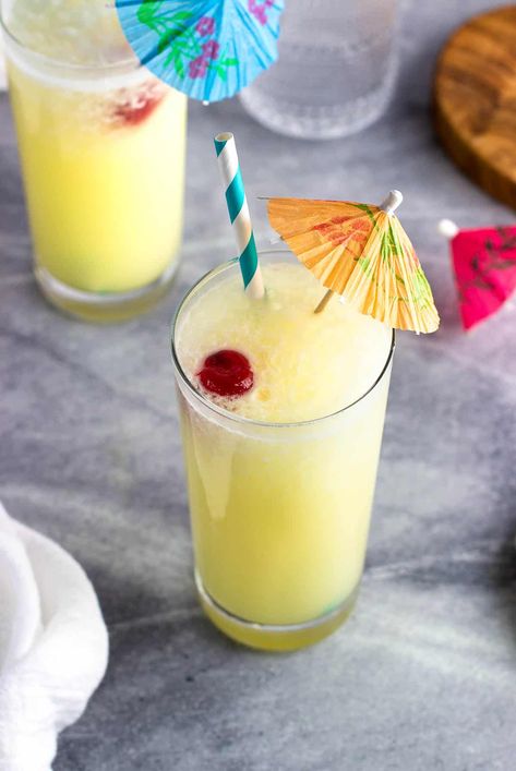 Enjoy the flavors of a tropical drink classic without the booze in this easy-to-sip piña colada mocktail. Written to serve two, this recipe is easy to scale up and serve both blended and on the rocks in a pitcher. You'll be in vacation mode in minutes. Cocktail Without Alcohol, Pina Colada Mocktail, Pina Colada Drinks, Tropical Drink, On The Rocks, Vacation Mode, Pina Colada, Non Alcoholic, Mocktails