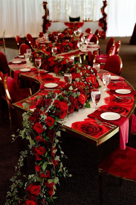 Luxurious red rose runners cascade over tables, creating an opulent wedding reception design. A dramatic and unforgettable statement. Romantic Red Rose Wedding Theme, Red And Blush Wedding, Rose Tablescape, Red Rose Wedding Theme, Wedding Reception Romantic, Reception Designs, Luxury Event Design, Rose Wedding Theme, Red Gold Wedding