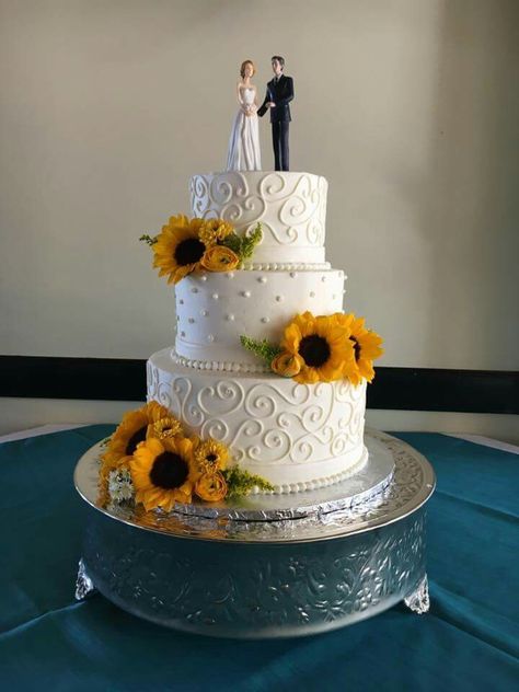 Sunflower Wedding Cake at Vics on the River in Savannah, GA - Cake by Baker's Pride, Flowers provided by Kato Floral Design, and Cake Topper by Wedding Collectibles - Sunflower Wedding #beaudoinbash #Savannah #wedding #savannahwedding #sunflowerwedding #sunflower #sunflowerweddingcake #bride #katofloraldesign #bakerspride #bakersprideofsavannah #vicsontheriver #weddingcollectibles Sunflowers Wedding Cake, Sunflower Cake Wedding, 2 Tier Sunflower Wedding Cake, Fall Sunflower Wedding Cake, Wedding Cake Sunflower And Roses, Sunflower Rose Wedding Cake, Wedding Cake No Fondant, Simple Sunflower Wedding Cake, Rustic Sunflower Wedding Cake