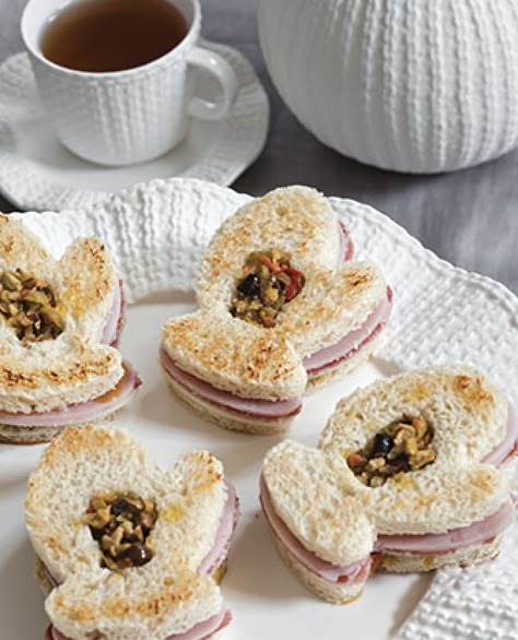 For many of us, this week has been comprised of frigid temperatures and a plethora of snow. Warm up this winter by enjoying a comforting teatime with our Mitten Muffuletta Tea Sandwiches paired with a tea blend of your choosing. A New Orleans favorite takes on a new twist in this charming and delicious savory. Find the recipe, along with a terrific selection of other winter-themed fare, by visiting https://www.teatimemagazine.com/warming-winter-recipes/. Tea Time Magazine, Tea Treats, Tea Party Sandwiches, Tea Sandwiches Recipes, Winter Warmers Recipes, Tea Time Food, Party Sandwiches, Winter Tea, Finger Sandwiches