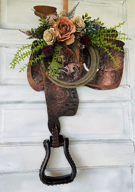 Saddle Floral Arrangements, Spur Decor Ideas, Saddle Wall Decor, Old Saddle Decor Ideas, Horse Door Hanger, Western Wall Colors, Saddle Decor Ideas, Repurposed Doors Ideas, Western Flower Arrangements