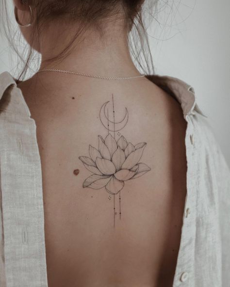 Lotus flower and crescent moon tattooed on the upper back Lotus Tattoo Back, Dainty Flower Tattoos, Arrow Tattoos For Women, Small Lotus Tattoo, Tattoos Tiny, Flower Spine Tattoos, P Tattoo, Flower Tattoo Back, Triangle Tattoos