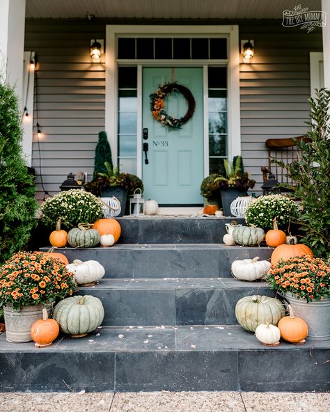 Beautiful Fall porch with pumpkins, mums, soft orange and aqua blue green. Plastic Pumpkin Flower Pot, Green Fall Decor, Pumpkins Porch, Breakfast Nook Decor, Pumpkin Porch, October Decor, Fall Porches, Fall Entry, Mums In Pumpkins