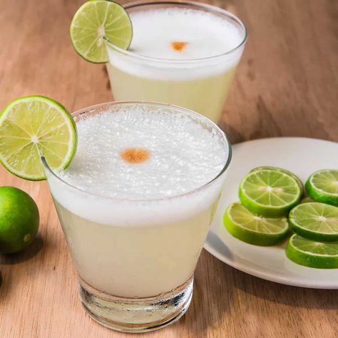 A pisco sour is an alcoholic cocktail of Peruvian origin that is typical of the cuisines from Peru and Chile. The drink's name comes from pisco, which is its base liquor, and the cocktail term sour, in reference to sour citrus juice and sweetener components. A pisco sour is an alcoholic cocktail of Peruvian origin that is typical of the cuisines from Peru and Chile. The drink's name comes from pisco, which is its base liquor, and the cocktail term sour, Pisco is a Peruvian grape distillate and i Peruvian Restaurant, Sour Foods, Pisco Sour, Summertime Drinks, Alcoholic Cocktails, Drinking Around The World, Peruvian Recipes, Citrus Juice, Negroni