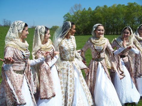 A group of young women sporting beautiful, pale hued traditional Chechen folk costumes Czech Traditional Clothing, Czech National Costume, Caucasus Traditionell Dress, Macedonian Folk Costume, Tuvan Traditional Clothing, Costumes Around The World, National Dress, Azerbaijan, Folk Dresses