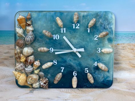 Resin clock with mica powder added for a shimmering ocean effect and florida shells #shellart #seashells #paintedseashells #seashellart #paintedshells #giftideas #beachlife #coastalstyle #coastaldecor #shellcraft #beach #sea #ocean #sealife Bubble Clock, Painted Clocks, Florida Shells, Seashell Creations, Ocean Ideas, Resin Sea, Seashell Art Diy, Resin Clock, Clock Painting