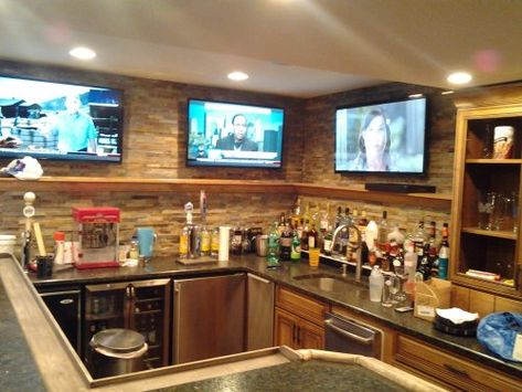 Multiple flat panel tv's mounted on brick wall of home basement bar. Home Basement Bar, Bar Plans Diy, Modern Basement Bar, Rustic Basement Bar, Basement Bar Plans, Home Basement, Basement Bar Design, Basement Bar Designs, Recreational Room