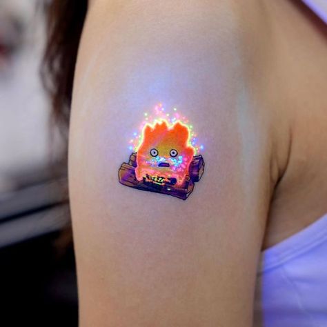 chewy jelly🧠 on Instagram: "The Calcifer of Howl’s Moving Castle🔥 #uvtattoo #uv타투" Howl's Moving Castle Tattoo, Sydney Tattoo, Pastel Tattoo, Tattoos Creative, Castle Tattoo, Uv Tattoo, Ghibli Tattoo, Flower Wrist Tattoos, Tasteful Tattoos