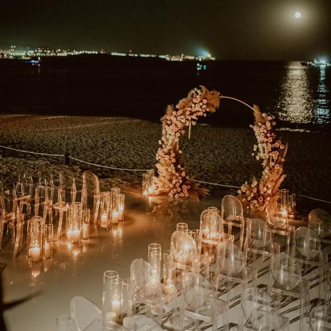 A nighttime beach wedding ceremony is something we never knew we needed. This stunning ceremony featured acrylic wedding decor and a rose with wildflower arch that looked out onto the ocean. Plus, this is the perfect way to have a beach wedding while keeping your wedding guests out of the hot summer sun! Head to the link for more beach wedding ideas you'll love. // Photo: Allan Carrazco Photographer, Planner: Amy Abbott Events and Florals: Cristina Gonzalez Night Beach Weddings, Nighttime Beach, Beach Wedding Ideas, Deco Ballon, Dream Beach Wedding, Beachy Wedding, Ocean Wedding, Dream Wedding Venues, Beach Wedding Inspiration