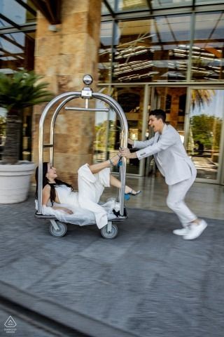 At Hotel Sofitel Cardales in Cardales, Argentina, the couple enjoyed a playful and fun lifestyle portrait session on a luggage cart ride Luggage Cart Photoshoot, Trolly Wedding Pictures, Hotel Wedding Shoot, Wedding Couple Poses In Hotel, Trolley Wedding Photos, Engagement Photos Carousel, Lifestyle Photography Couples, Engagement Images, Wedding Engagement Pictures