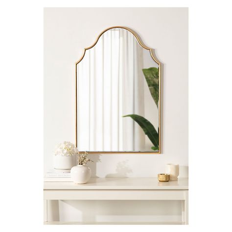 Showcase your glamorous, elevated aesthetic in your home by hanging the Leanna mirror on your wall. Inspired by the elegant curvature of sophisticated vintage art pieces, the Leanna features an arched shape with a scalloped edge on either side. Along this beautiful frame, you'll find a jaw-dropping gold leaf finish that was applied by hand, giving it a customized, one-of-a-kind look that radiates decadence. The overall dimensions of the Leanna wall mirror are 20" wide by 30" tall, making it a stellar statement piece for any wall in your home. Use the lovely Leanna mirror to elevate elegance in your living room, bedroom, entryway, or dining room. It captivates your guests as its own focal point or dazzles in a display of multiple mirrors. The ample surface area of this mirror allows it to s 2023 Apartment, Glamorous Bathroom, Multiple Mirrors, Apartment Vibes, Hampton House, Framed Wall Mirror, Gold Bathroom, Framed Mirror Wall, Gold Walls