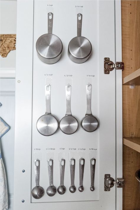 Learn how to organize your measuring cups so you never lose them again! Using Command hooks, you can turn wasted space inside a cabinet door into practical storage. Measuring Cups Organization, Measuring Cup Organization, Kitchen Organisation Hacks, Stairs Makeover, Inside Cabinets, Kitchen Refresh, Command Hooks, Kitchen Hacks Organization, Diy Stairs