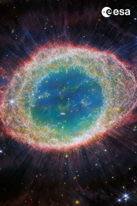 This image of the Ring Nebula appears as a distorted doughnut. The nebula’s inner cavity hosts shades of blue and green, while the detailed ring transitions through shades of orange in the inner regions and pink in the outer region. The ring’s inner region has distinct filament elements Ring Nebula, Hubble Space Telescope Images, Planetary Nebula, Astronomy Lover, Hubble Telescope, James Webb, James Webb Space Telescope, Hubble Space, Hubble Space Telescope