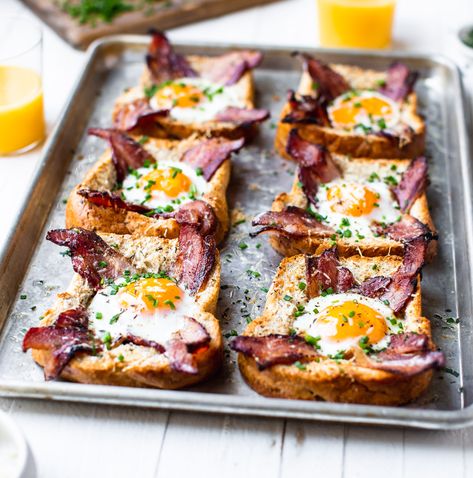 Sheet Pan Egg In A Hole - TableandDish Egg In A Hole Avocado Toast, Frog In A Hole Breakfast, Egg Hole Toast, Baked Egg In A Hole, Egg In The Basket, Eggs In Toast Hole, Egg In Toast Hole Oven, Egg In Hole Toast, Eggs In A Hole Recipe