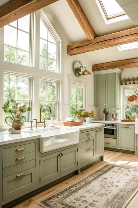 Combine sage green cabinets with classic farmhouse elements like a farmhouse sink and natural wood beams for a cozy, charming kitchen. This style blends country living with modern sophistication. Green Cabinets With Bronze Hardware, Modern Farmhouse Cottage Interior Design, Sage Green Country Kitchen, Sage Farmhouse Kitchen, Sage And Gold Kitchen, Sage And Wood Kitchen, Green And Natural Wood Kitchen, Country Cottage Kitchen Ideas, Green Cabinet Kitchen