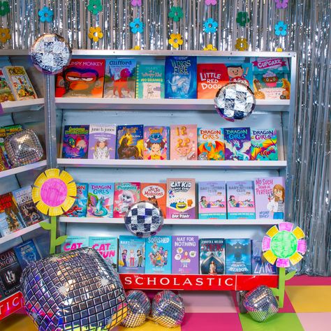 Since it's spring dance season, turn your book fair into a colorful disco party with sparkly streamers, inflatable disco balls, a construction paper dance floor, and a playlist full of fun party tunes. Scholastic Book Fair Aesthetic, Spring Book Fair Themes, Colorful Disco Party, Book Fair Themes, School Book Fair, Cupcake Diaries, Book Fairs, Fair Theme, Scholastic Book Fair