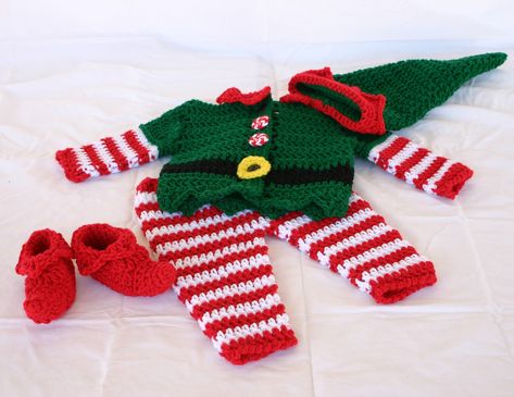 Baby elf costume. 0-3 month. Crocheted. This adorable crocheted baby elf costume is perfect for your Christmas baby. The pants are made with red and white stripes. The shoes are red with a stuffed curl at the toe. The hat is green with red trim around the edge. The jacket is mostly green, with red and white striped sleeves, a black stripe around the waist, a red collar, a yellow buckle, and red and white striped yarn buttons. The buttons at the neck and the buckle are black. This set makes a gre Baby Elf Costume, Crochet Cottage, Costume Crochet, Crochet Baby Costumes, Baby Elf, Baby Kostüm, Christmas Suit, Elf Clothes