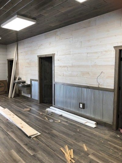 How to Make Wood Paneling Look More Modern | Northern Log Remodel Wall Paneling, Rustic Wood Paneling Walls, Wood Walls Basement, Raw Wood Paneling, Shiplap And Corrugated Metal Wall, White Barnwood Wall, Tin Half Wall, Paneling In Garage, Metal Siding Interior Walls