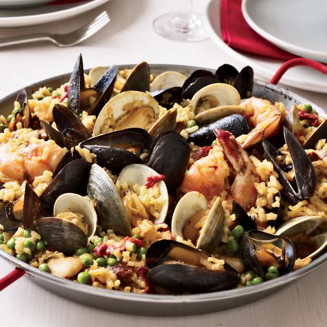 Chef Way Seamus Mullen cooks the rice for this chicken-and-seafood paella as if it were risotto, adding chicken stock gradually.  Easy Way Stir stoc... Valenciana Recipe, Seafood Paella Recipe, Spanish Paella Recipe, Paella Recipe Seafood, Chicken Paella, Traditional Spanish Recipes, Spanish Paella, Recipes Fish, Paella Valenciana