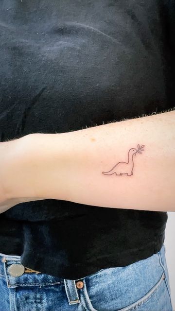 Simple Tattoos Dinosaur, Small Dinasour Tattoos, Tiny Dino Tattoo Cute, Dinosaur Tattoo Minimalist, Fine Line Tattoo Dinosaur, Dino Line Tattoo, Dinsors Tattoo, Brontosaurus Tattoo Cute, One Line Dinosaur Tattoo