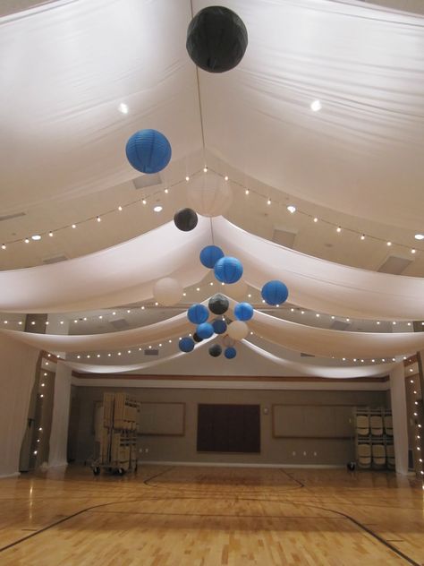 I wouldn't mind having our reunion on our old gym if it looked like this! Drape with colored lanterns School Dance Ideas, Class Reunion Decorations, Night To Shine, Reunion Decorations, Dance Decorations, Ceiling Draping, Memory Table, Prom Decor, Prom Theme