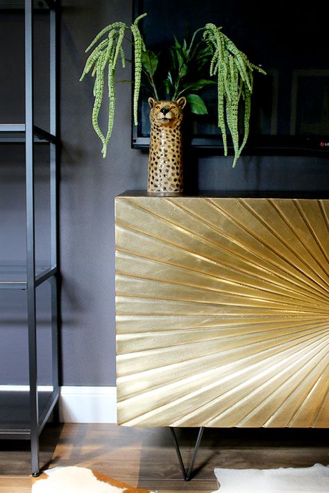 Glam Cave gold sideboard against dark walls Cheetah Sitting, Gold Sideboard, Sideboard Gold, Alcove Cupboards, Thursday Inspiration, Statement Furniture Pieces, Gold Sunburst, Affordable Interior Design, Mid Century Living