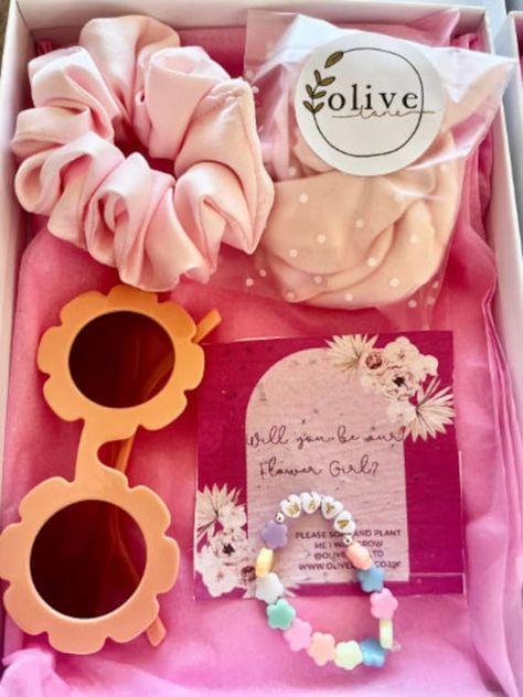 Personalised Flower Girl Proposal box Bracelet, Flower Sunglasses, Satin Petals and Hair Scrunchie all in a gift box lined with white tissue paper and frayed chiffon ribbon. - Beaded Flower bracelet with your flower girl's name which is attached to some seed paper with 'Will You Be Our Flower Girl?' on it. - Blue Flower Sunglasses - Handmade silk hair scrunchie - Light blue satin reusable flower girl petals - White Gift Box lined with tissue paper and tied with ribbon. Perfect proposal gift box Flower Girl Proposal Ideas, Asking Flower Girl, Flower Girl Petals, Hen Party Bags, Flower Girl Proposal, Flower Sunglasses, Handmade Sunglasses, Flower Girl Bracelets, Perfect Proposal