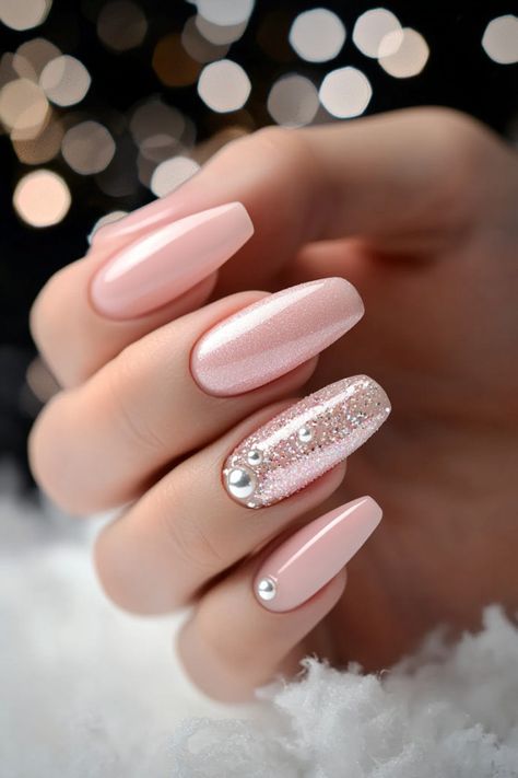 14 Creative Pink Christmas Nails for Every Style Light Pink Xmas Nails, Pastel Pink Nails With Glitter, Peach Christmas Nails, Pink Glitter And Chrome Nails, Pink And Silver Dip Nails, Winter Nails Light Pink, Pink And White Nails With Glitter, Light Pink Nails With Stars, Cute January Nails Pink