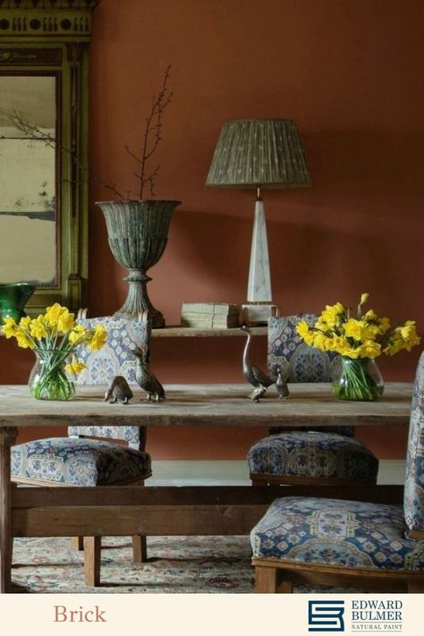 A rustic spring dining room scenes with an eclectic collection of antique pieces from @lorfordsantiq The walls are painted in our shade 'Brick' which is a wonderfully warm earthy hue similar to the natural materials of clay and terracotta. We have been firing clay to make bricks for a very long time and we are used to seeing them mellowed with age. ⁠ To find out how to decorate with on trend earthy colours like this one, visit our blog - link attached. Terracotta Dining Room, Firing Clay, Spring Dining Room, Edward Bulmer, Natural Paint, Earthy Colours, Mood Colors, Eco Friendly Paint, Natural Heritage