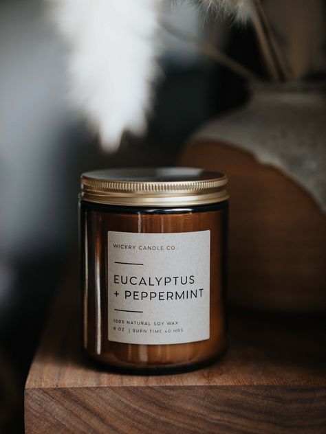 "*New name, same great scent!* Our Eucalyptus + Peppermint soy candle blends sweet peppermint with tingly, earthy eucalyptus for a refreshing spa-like scent that will ease and calm your mind. Perfect for those days when you need a little extra stress relief. NOTE PROFILE: Top: Eucalyptus, Peppermint Middle: Cedar, Clove Base: Patchouli, Vanilla, Powder This fragrance is infused with natural essential oils, including eucalyptus oil, cornmint oil, cedarwood oil, and patchouli oil. CANDLE DETAILS: Candle Photography Inspiration, Peppermint Candle, Patchouli Candle, Peppermint Candles, Herbal Candles, Esential Oils, Vanilla Powder, Candle Projects, Candle Making Business