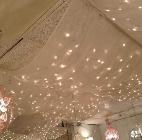 Twinkly Ceiling Lights, Draping Lights From Ceiling, Tule Curtain Ideas, Cover Ceiling With Fabric, Ceiling Drapes With Lights, Unfinished Basement Room Ideas, Curtain Lights On Ceiling, Diy Massage Room, Fabric Ceiling Ideas Bedroom