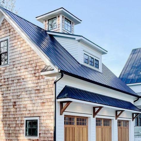 George | The DIY Warrior on Instagram: "Cedar shakes are the little black dress of exterior design.   Let’s also not forget about these beautiful Cedar Full Overlay garage doors by chioverheaddoors #chioverheaddoors   #cedar #cedarshakes #cedarshake #metalroofing #metalroof #jameshardie #chantillylace #coupula #newbuild #newbuildhome #newconstruction #newhome #waterfront #warerfronthomes #brickwork #newconstructionhomes #carolinahomes #coastalvibes #coastalfarmhouse #coastalliving #waterfrontrealestate #farmhouse #modernfarmhouse #moderndesign #exteriorhome #homegoals #housegoals #peepmypad #cljsquad" Cedar Shake Farmhouse, Garage Dormers Ideas Exterior, Cedar Shakes On Gables House, House Gables Exterior, White House Black Roof Wood Accents, Brick And Cedar Shake Exterior, Cedar Gables On House Exterior, White And Cedar House Exterior, Shake Siding Exterior