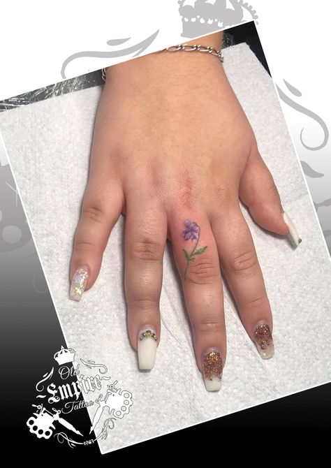 Our newly qualified apprentice loved doing this cute miniature violet! #VioletTattoo #FlowerTattoo #MiniatureTattoo #TattooApprentice #ColourTattoo #FingerTattoo #FeminineTattoo #GirlsWithTattoos #SmallTattooIdeas #OldEmpireTattoo @OldEmpireTattoo Violet Finger Tattoo, Violet Flower Hand Tattoo, Flower Finger Tattoos, Violet Flower Tattoos, Violet Tattoo, Empire Tattoo, Wedding Finger, Wedding Ring Tattoo, Tattoo Wedding Rings