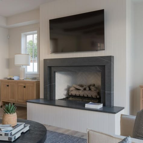 In her great room that connects to her kitchen designer Brooke Wagner wanted a raised family room fireplace where her kids and relatives could sit on the hearth and warm up together. With this is mind Wagner designed a clean, simple and understated fireplace for her new home and turned to fabricator Fred Paulk to bring it to life. Paulk achieved this with Polycor's American Black Granite. Granite Fireplace Mantle, Black Soapstone Fireplace, Black Granite Fireplace Surround, Granite Mantle, Soapstone Fireplace Surround, Black Granite Fireplace, Granite Fireplace Surround, Create A Fireplace, Soapstone Fireplace