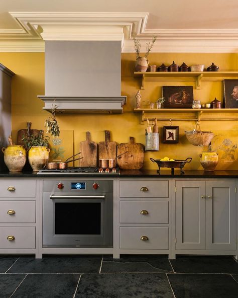 Sunny yellow walls and a wonderful collection of old pots and chopping boards and copper pans. Our little bit of the Mediterranean in New… Ochre Kitchen Walls, Kitchen With Yellow Walls, Ochre Kitchen, Devol Shaker Kitchen, Popular Kitchen Colors, Shaker Kitchen Design, Best Kitchen Colors, Серая Кухня, Devol Kitchens